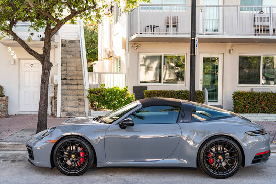 Miami, Florida, USA - July 27, 2025: Porsche 911 Carrera 2023 GTS Cabriolet convertible car. Luxury car Porsche 911 Carrera. Car Porsche 911 Carrera parked outdoor. Grey convertible car, side view.
