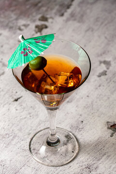 martini with olive and a paper parasol to celebrate summer.