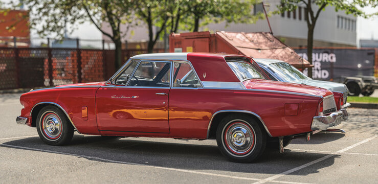 Gothenburg, Sweden - May 30 2026: Side profile of red Studebaker Gran Turismo Hawk at show.