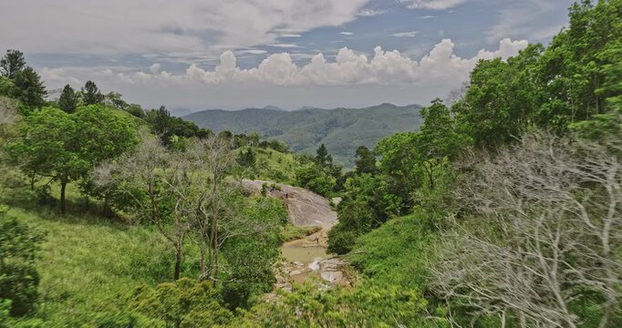 Diyaluma Sri Lanka Aerial v2 dramatic flyover along the creek, winding through verdant valleys, bird's eye view of cliffside waterfalls surrounded by dense jungle - Shot with Mavic 3 Cine - April 2023
