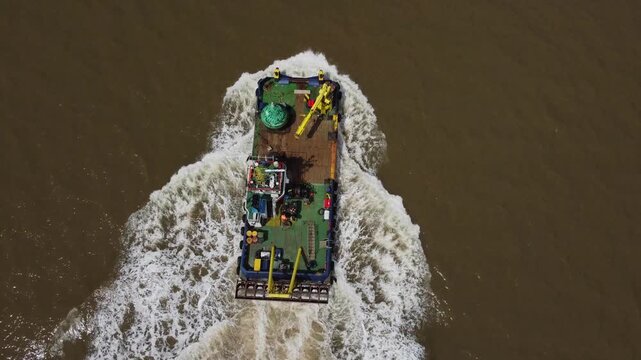 Drone view of a mini dredger carrying out maintenance work on the River Humber. 