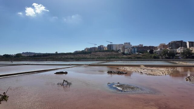 Salina, Malta - 06.07.2026 - Salina Nature Reserve, View of salt pans with buildings to the rear in Salina Bay, Bugibba, Malta.