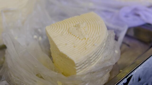 Brynza cheese. Fresh homemade brynza cheese sold at local market traditional dairy product packed and weighed for customer