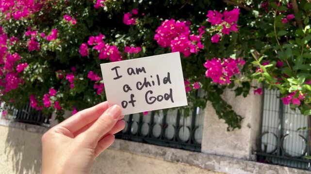 I am a child of God - christian text with pink flowers background, faith and encouragement