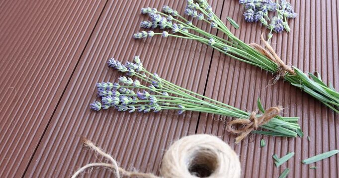 lavender arrangement on wooden surface with calm and natural mood top-down view home decor natural products brown green string twine clean background copy space editorial resource web page.