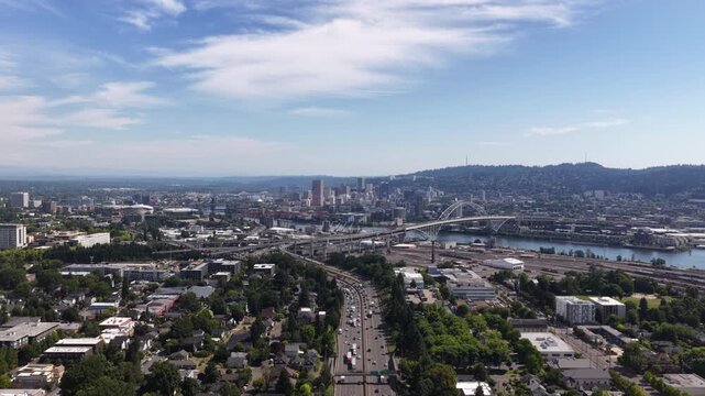 Aerial of downtown Portland Oregon and Willamette River on sunny summer day with skyscrapers and multiple bridges on Interstate 5