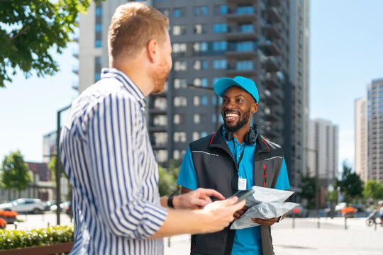 Customer signs digitally to confirm receipt of an online order during last-mile delivery.