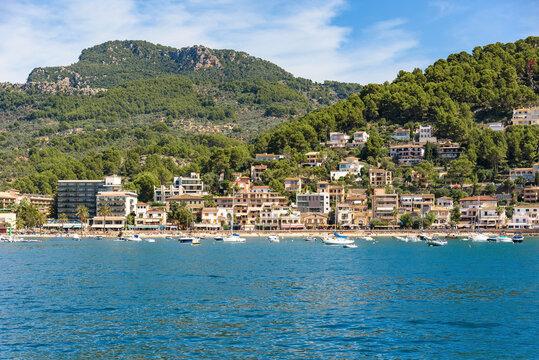Port de Soller hillside villas and waterfront town seen from the sea, Mallorca