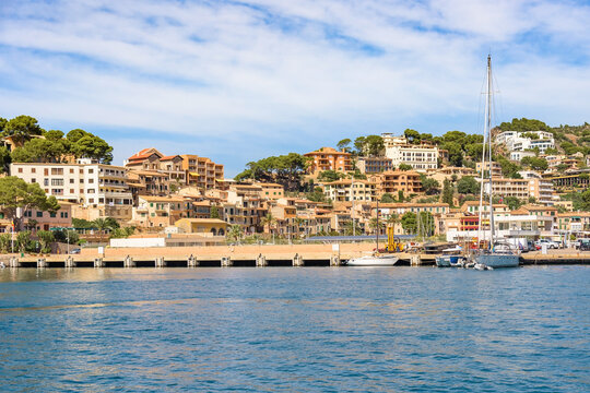 Port de Soller harbour with Mediterranean hillside buildings and moored boats, Mallorca