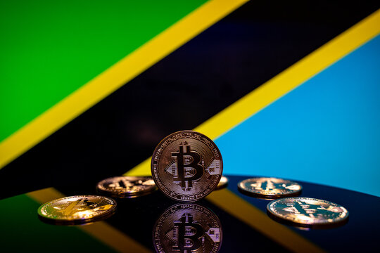 Close up of Bitcoin coins with Tanzania flag background.