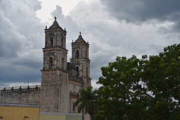 Fototapeta premium Ancient stone church bell towers against stormy clouds