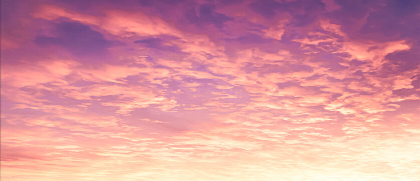 Beautiful sunset sky background with dense pink purple clouds texture and bright golden sun glow for panoramic travel design