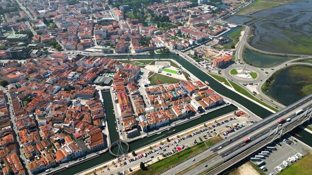 Drone flyby of Aveiro city streets, central river and boats