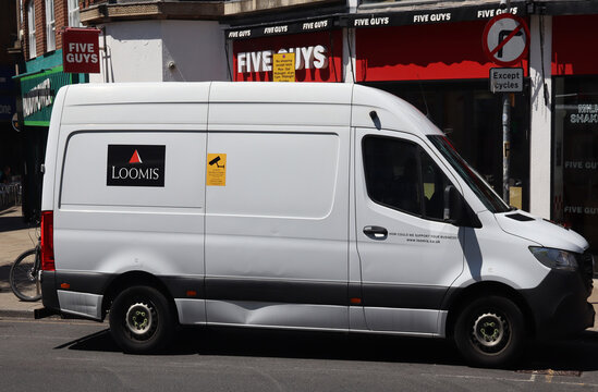 Norwich, United Kingdom - July 5, 2026: General street view in Norwich city centre White commercial van parked outside a retail store with advertising decals