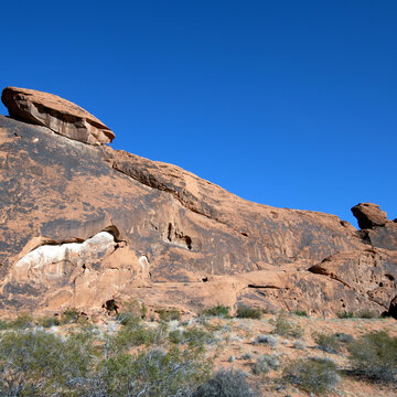 Evening light turns red sandstone formations orange in Valley of Fire State Park in Nevada, square image with copy space