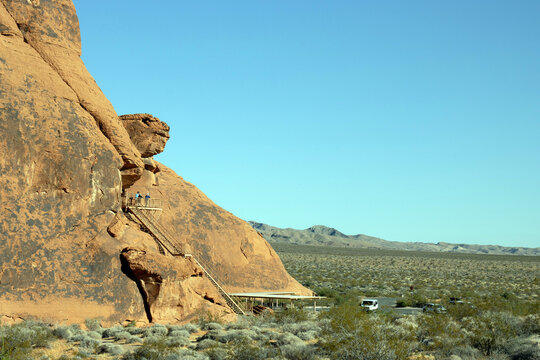 Visitors to the Atlatl Rock Overlook, an elevated metal staircase and platform, enjoy sweeping views of Valley of Fire State Park in Nevada