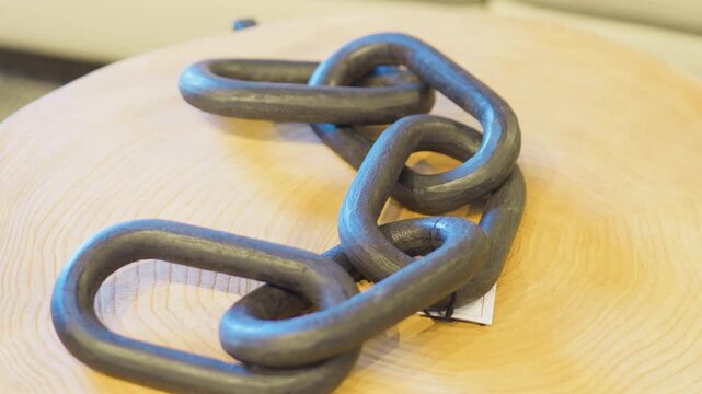 Decorative wood chain link sculpture on side table