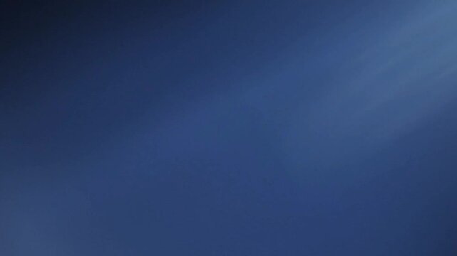 Blue light beams diffuse softly across a deep navy gradient atmosphere.