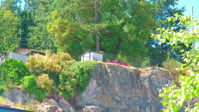 Residential property built on steep rugged rock cliff face
