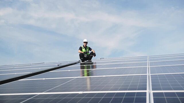 Technician installing rooftop solar panels for green energy, supporting renewable energy, clean power, sustainable technology and solar infrastructure.