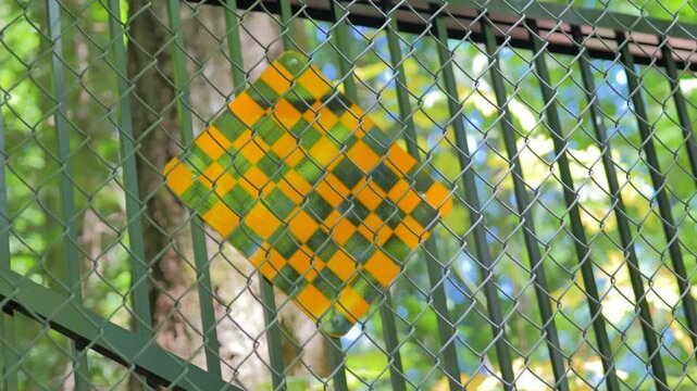 Abstract geometric background of woven diamond fence pattern