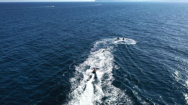 Aerial view of a group of wave runners sailing fast, in the coast of Torrevieja, Spain.