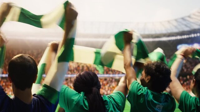 Close up of football supporters in stadium tribunes rocking sideways rhythmically, doing choreography with scarves, showing rear view of crowd swaying from side to side, creating organized fan chants.