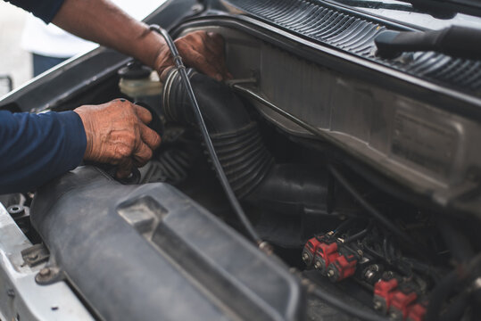 Mechanic hands repairing car engine.