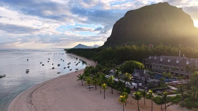 Golden hour aerial view of Le Morne Beach and lagoon beneath Le Morne Brabant