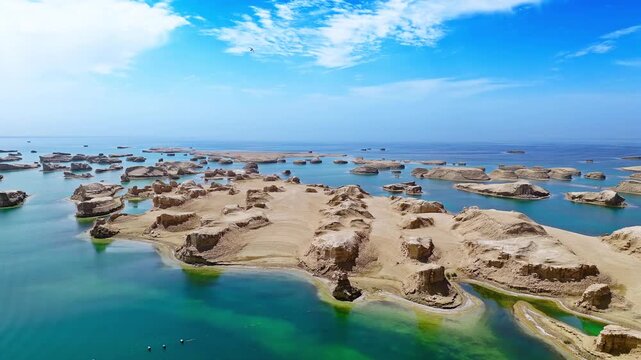 Aerial drone shot of water yardang landforms surrounded by turquoise water in the Qaidam Basin, Qinghai, China