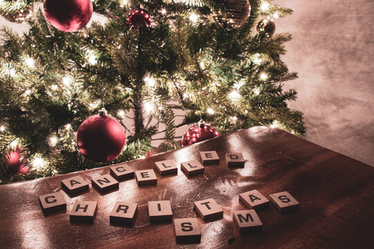 Wooden letters spelling CHRISTMASS CANCELLED due to COVID-19 restrictions