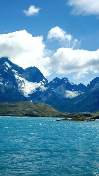 Torres del Paine National Park, Patagonia, Chile &mdash; a stunning view of turquoise lakes, rugged mountains, and snow-capped peaks under a bright blue sky