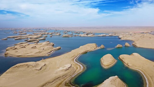 Aerial drone shot of water yardang landforms surrounded by turquoise water in the Qaidam Basin, Qinghai, China