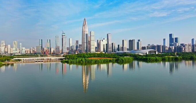 Aerial view of Shenzhen Bay skyline with modern skyscrapers reflected in the water, China