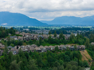 Fototapeta premium Suburban Homes and Scenic Valley View With Mountains Overlooking Chilliwack, British Columbia, Canada