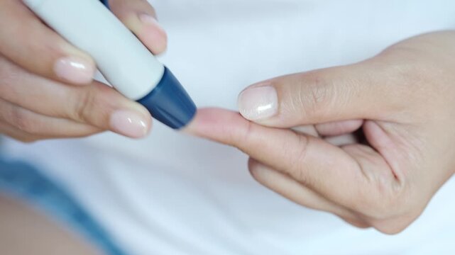 Woman's hands checking diabetes and hyperglycemia with digital blood sugar meter. Healthcare and medical concept	
