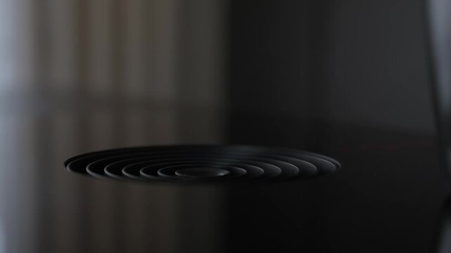 A cinematic close up of a sleek, black integrated downdraft kitchen extractor fan. Perfect for content focusing on modern home design, luxury appliances, and minimalist interior aesthetics.