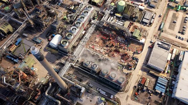 Aerial view of a huge chemical refinery with coking furnaces and industrial cooling fans in Immingham, UK.