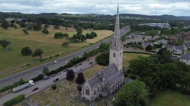 St Margaret's Marble church aerial view orbits neo gothic steeple in Rhyl parish and A55 motorway