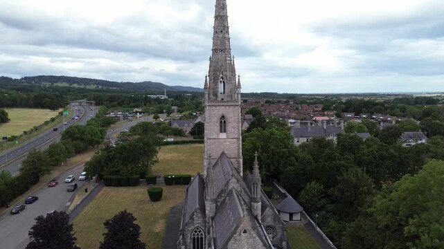 St Margaret's Marble church aerial view reverse away from gothic spire in Rhyl parish A55 motorway