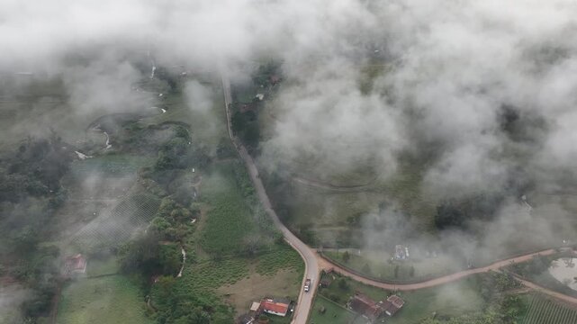 S&atilde;o Bento do Sapuca&iacute; at dawn, with a blanket of clouds over the valley. Aerial view. Flying above the clouds. Serra da Mantiqueira, Vale do Paraiba. Atlantic Forest