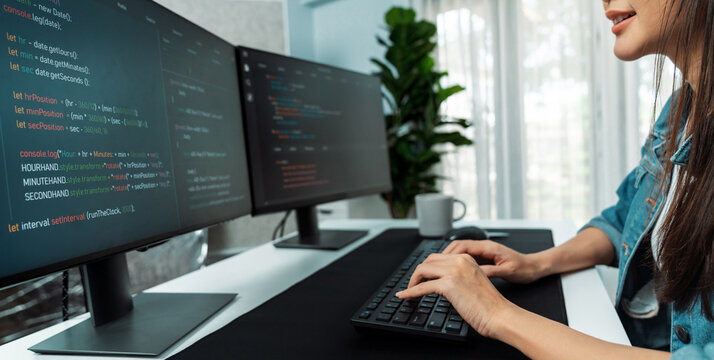 Young Asian in IT developer creating with typing online information on pc with coding program data of website application, wearing jeans shirt. surrounded by safety analysis two screens. Stratagem.