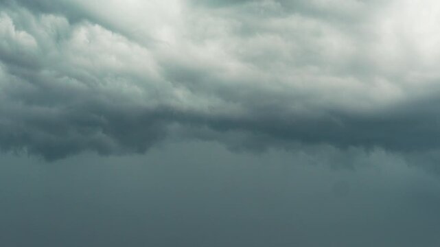 4k time lapse footage of rain clouds moving in sky, dark clouds rolling cross sky like painting, weather concept b roll shot.