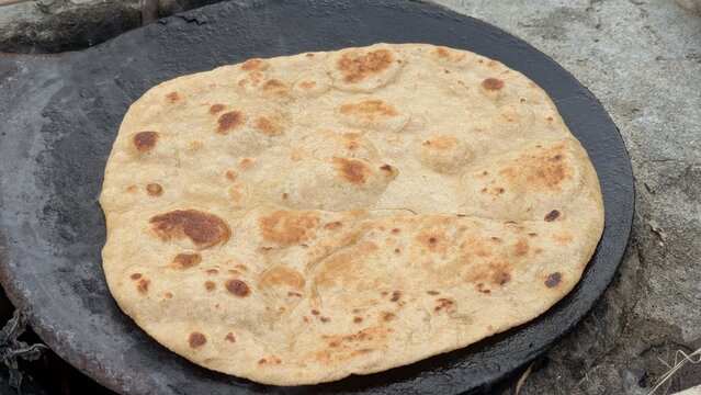 Fresh Homemade Roti Bread Cooking on Traditional Tawa
