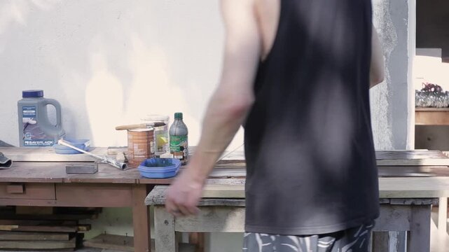 Close Up of a Man Painting Wooden Boards with Brown Paint, HD Video