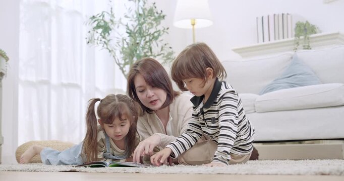 Single mother teaches counting with toy blocks beside open picture book, preschool son listens, toddler daughter watches, homeschooling learning game, childhood development, caring guidance at home.