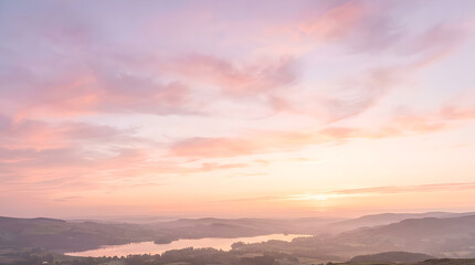 Fototapeta premium Serene Aerial Landscape of Rolling Hills and Lake at Sunset