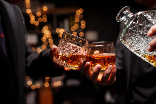 Businessmen Clinking Whiskey Glasses in Celebration Night