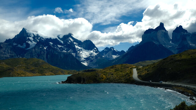A scenic mountain road through the breathtaking landscape of Torres del Paine National Park, with turquoise waters and rugged peaks in Patagonia, Chile