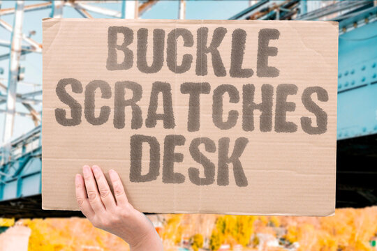 "Buckle Scratches Desk" Belt metal gouges table edge. BUCKLE. SCRATCHES. DESK. BELT. METAL.